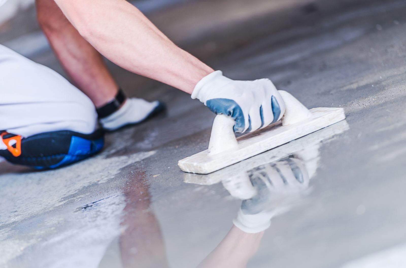 Installer troweling a floor coating repair