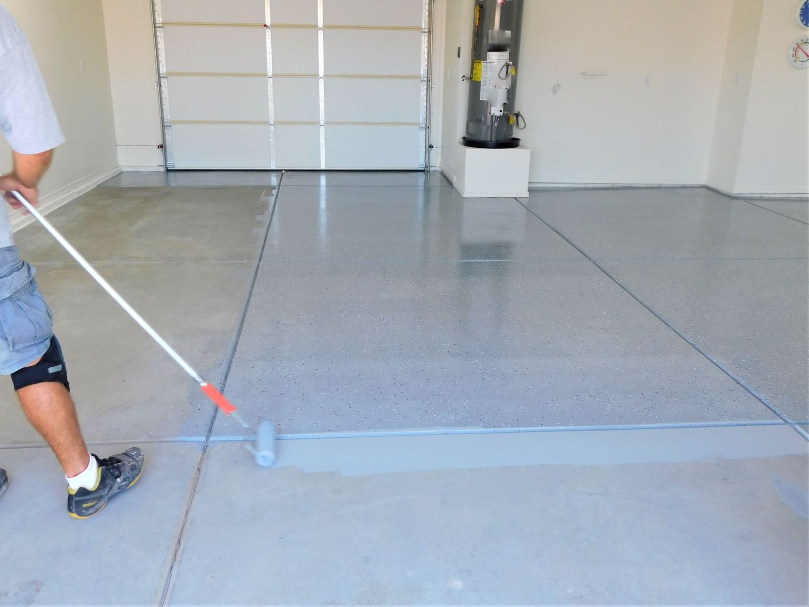 Rolling a polyaspartic topcoat in a Maricopa garage